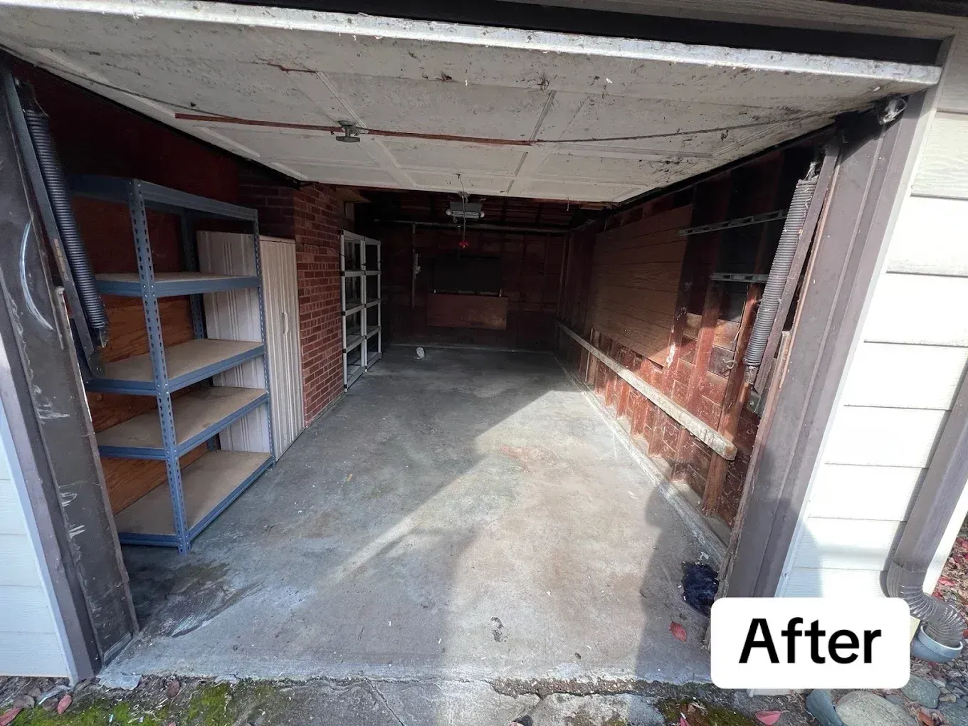 Open garage with concrete floor, shelving on left, brick wall on right, and “After” label in corner
