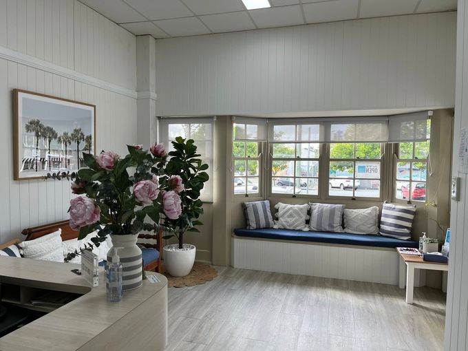 A Living Room With a Couch and a Picture on the Wall — Pollock Ingram Solicitors in Caloundra, QLD