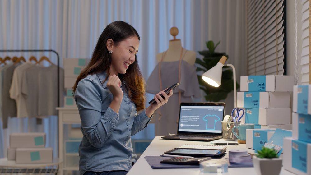 A Woman Is Smiling At Her Phone — Pollock Ingram Solicitors in Caloundra, QLD