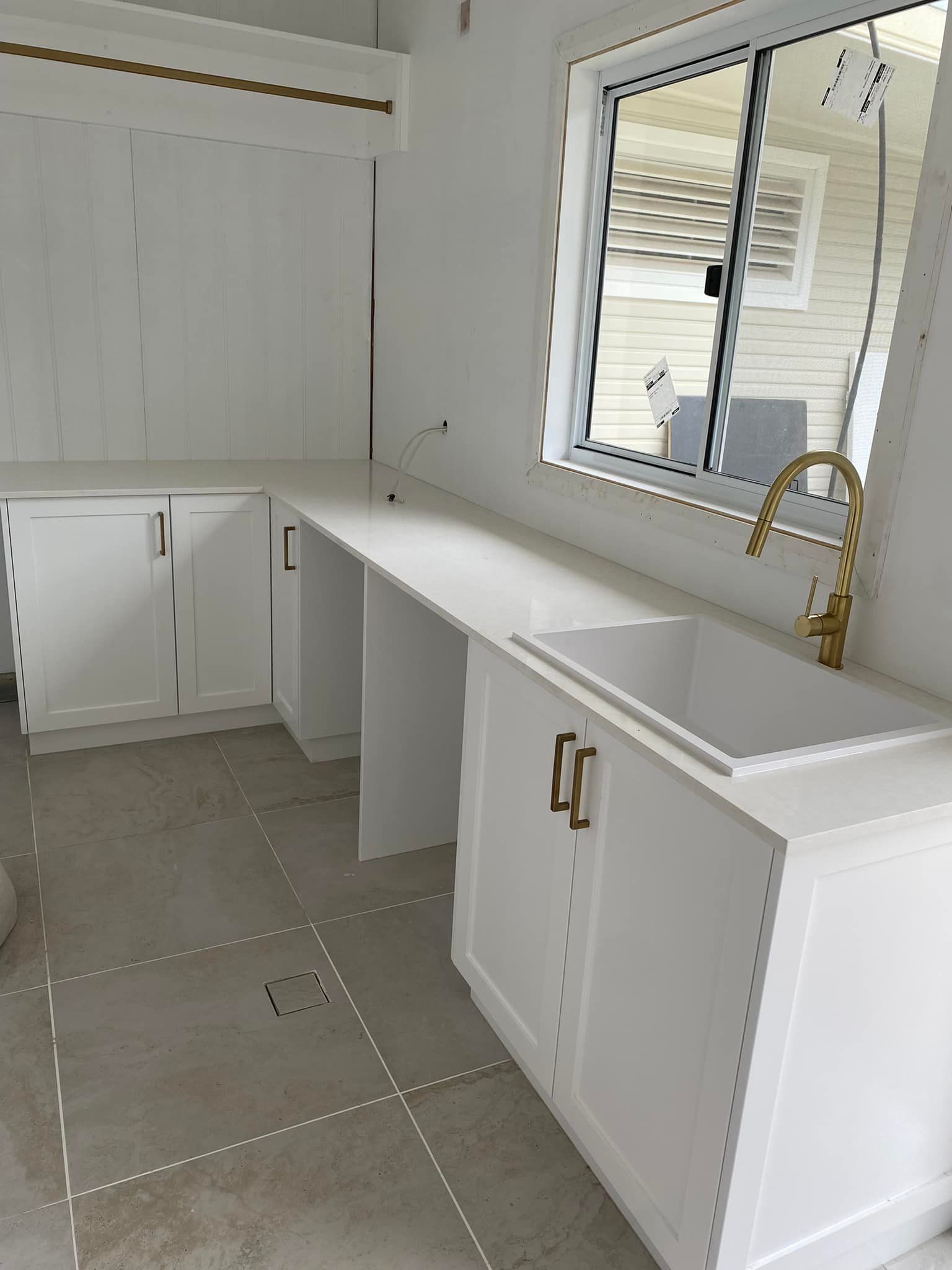 A Kitchen With White Cabinets, a Sink and a Window — Moore Than Just Kitchens In Tamworth, NSW