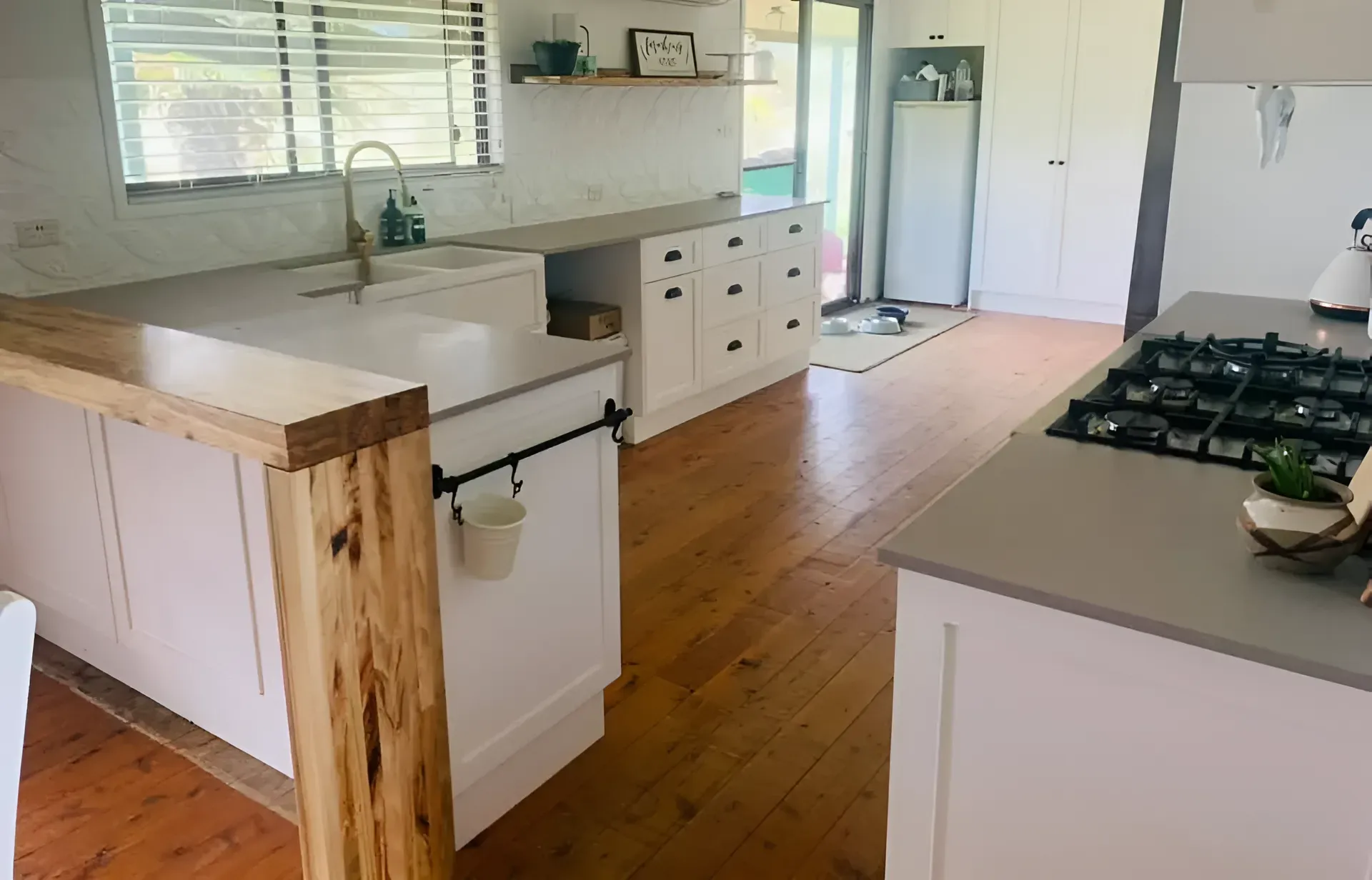 A Kitchen With White Cabinets, Wooden Floors, a Stove and a Sink — Moore Than Just Kitchens In Manilla, NSW