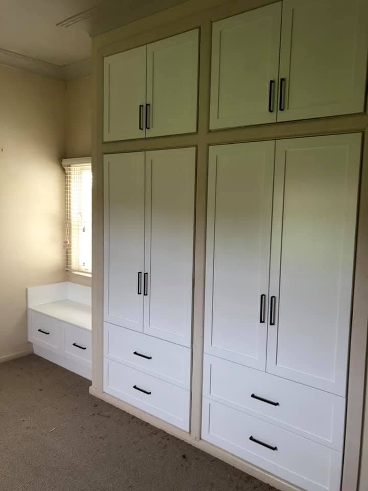 A Bedroom With White Cabinets and Drawers and a Window — Moore Than Just Kitchens In Manilla, NSW