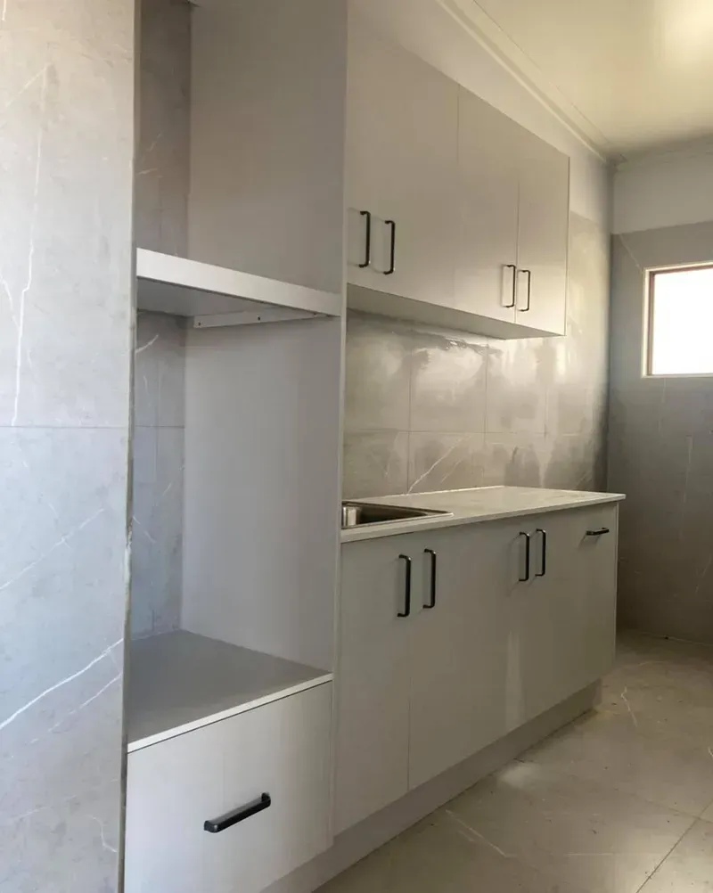 A Kitchen With White Cabinets and a Stainless Steel Sink — Moore Than Just Kitchens In Manilla, NSW