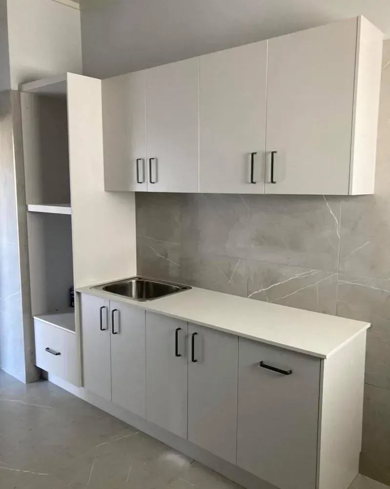 A Kitchen With White Cabinets and a Stainless Steel Sink — Moore Than Just Kitchens In Manilla, NSW