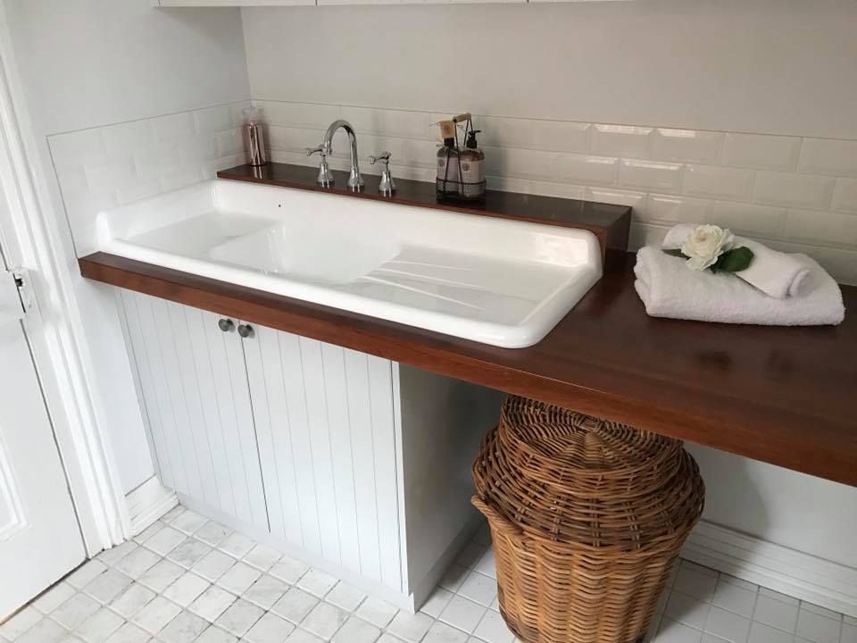 A Bathroom With a Sink and a Wicker Basket — Moore Than Just Kitchens In Wee Waa, NSW