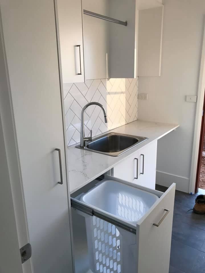 A Laundry Room With a Sink and a Laundry Basket — Moore Than Just Kitchens In Wee Waa, NSW