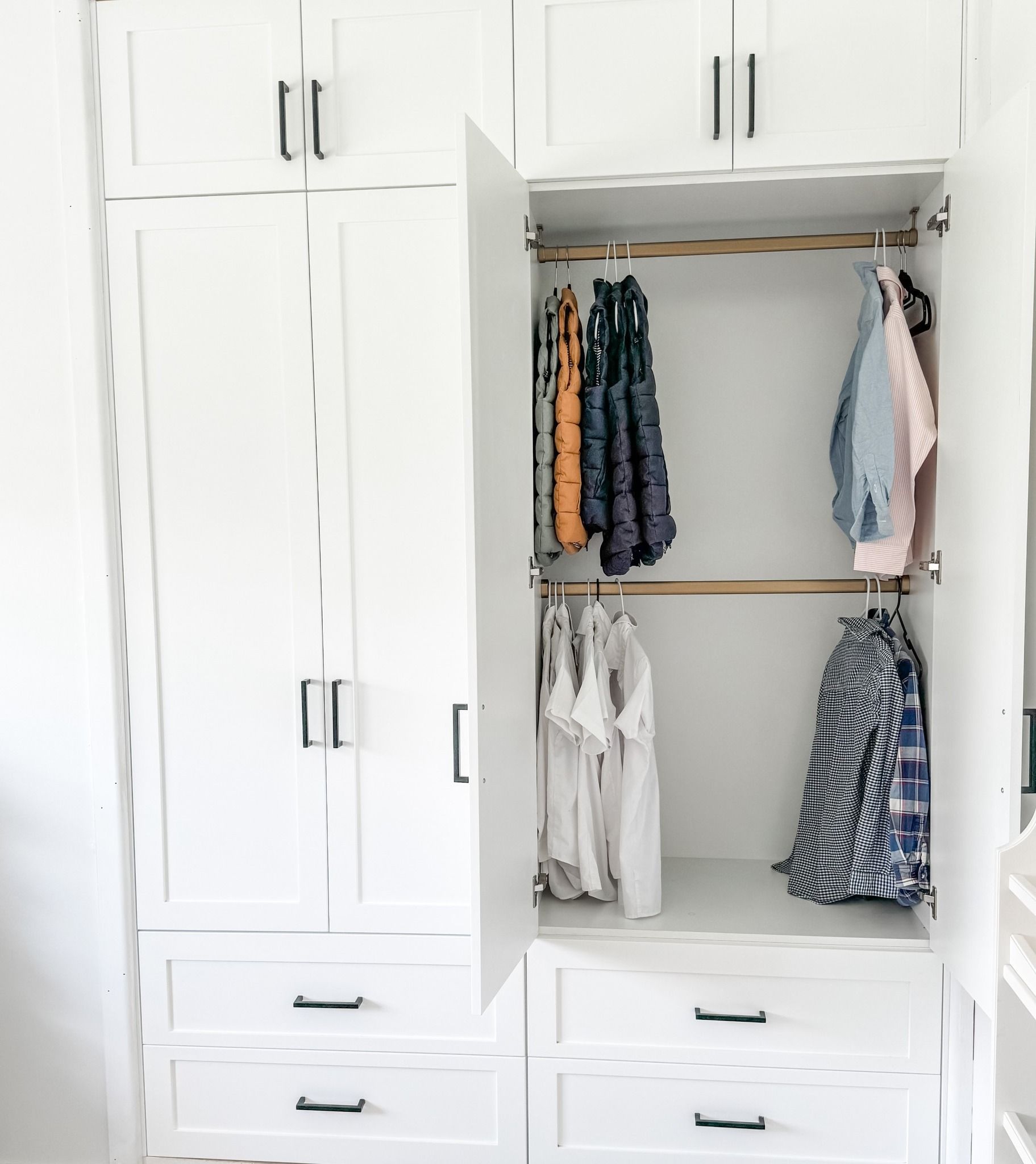 A White Closet With the Door Open and Clothes Hanging — Moore Than Just Kitchens In Manilla, NSW