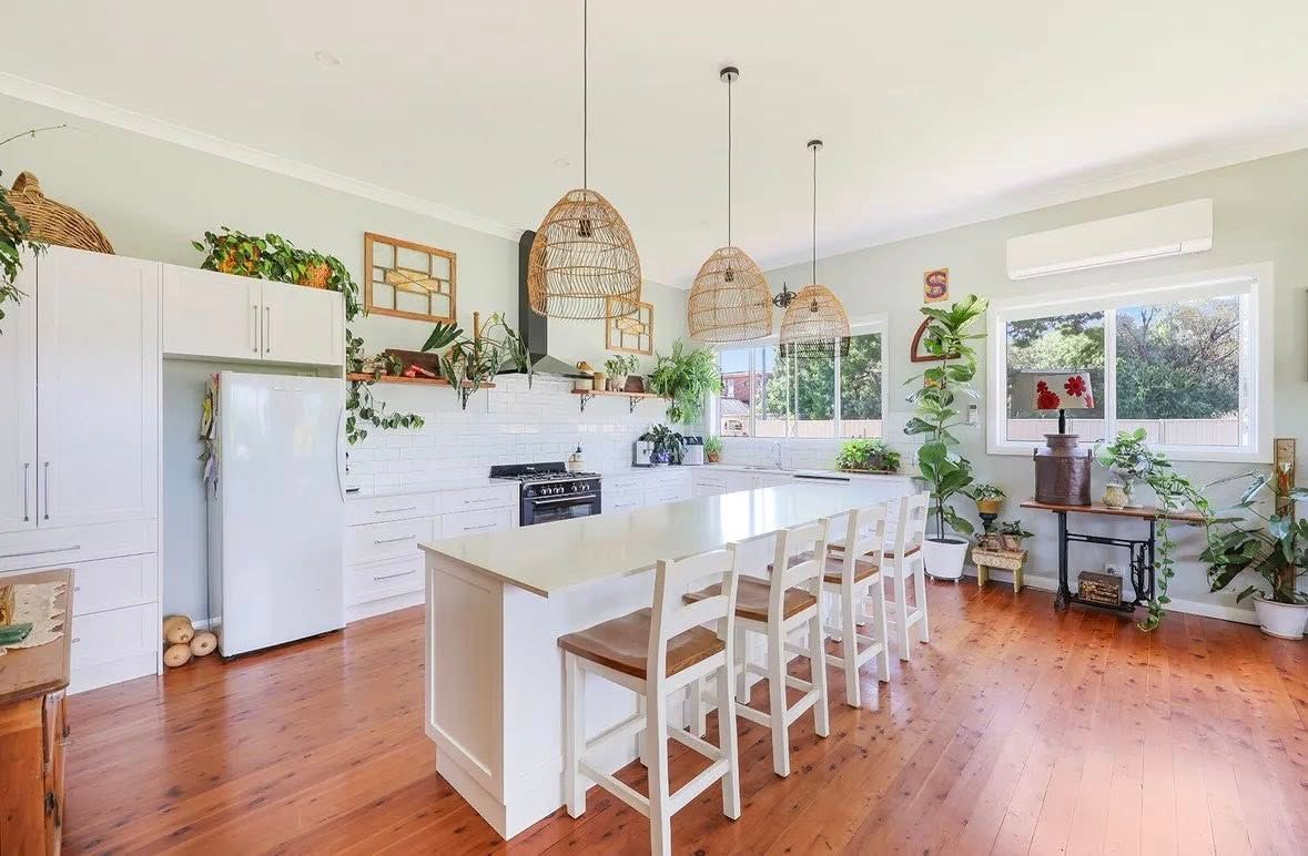 A Kitchen With a Large Island, Stools, a Refrigerator, and a Stove — Moore Than Just Kitchens In Manilla, NSW