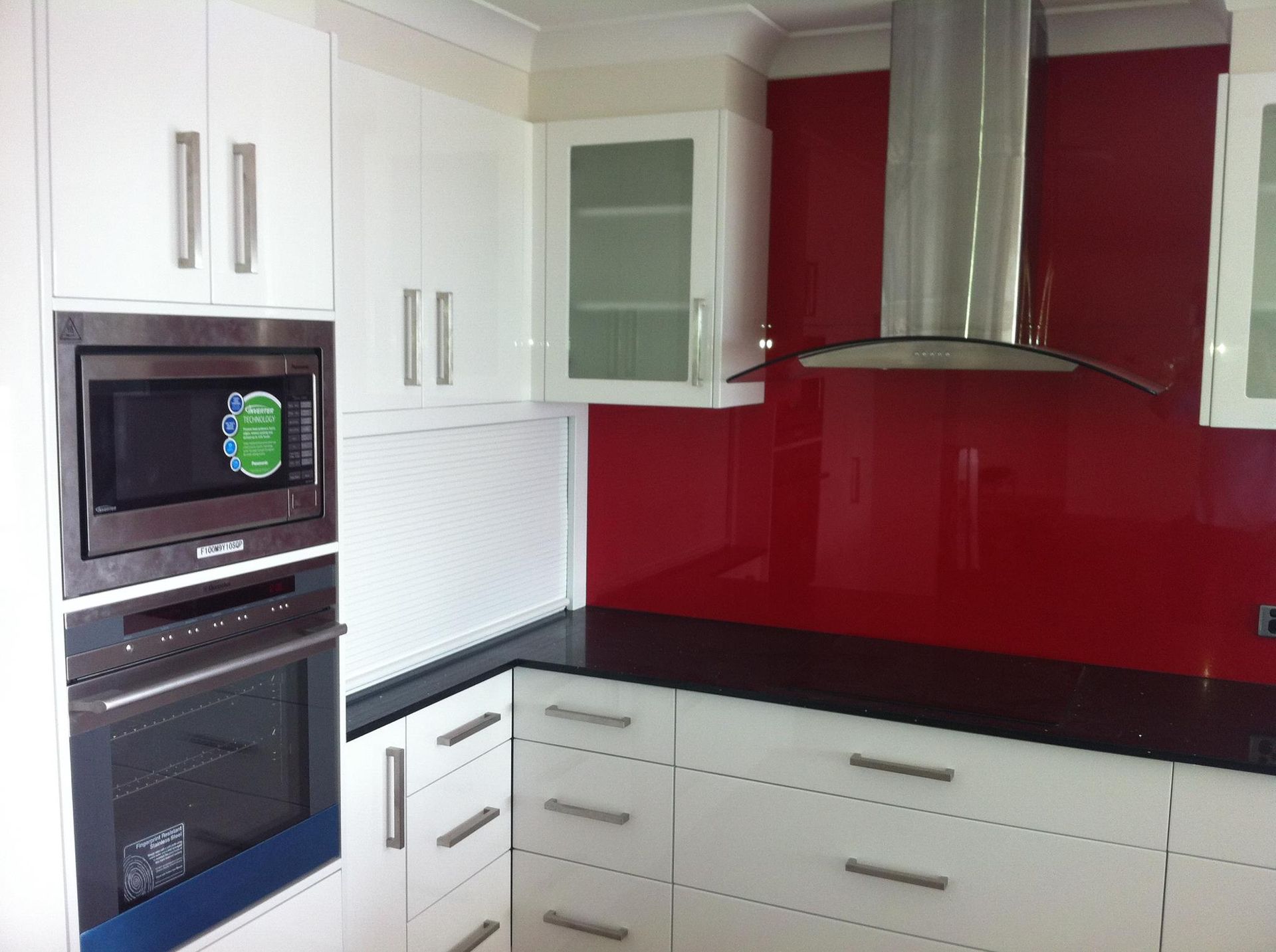 A Kitchen With Red Walls and White Cabinets — Moore Than Just Kitchens In Narrabri, NSW