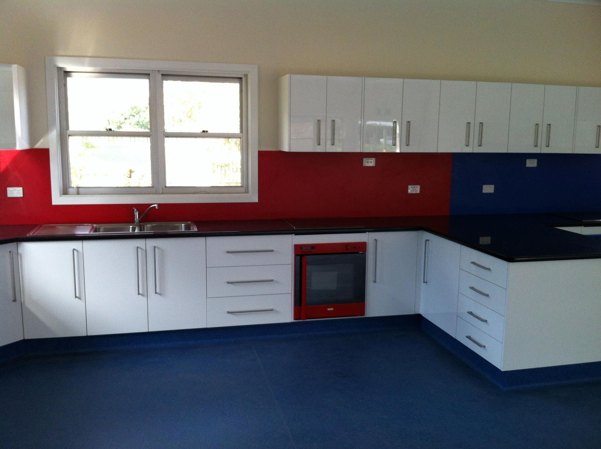 A Kitchen With Red White and Blue Cabinets — Moore Than Just Kitchens In Narrabri, NSW