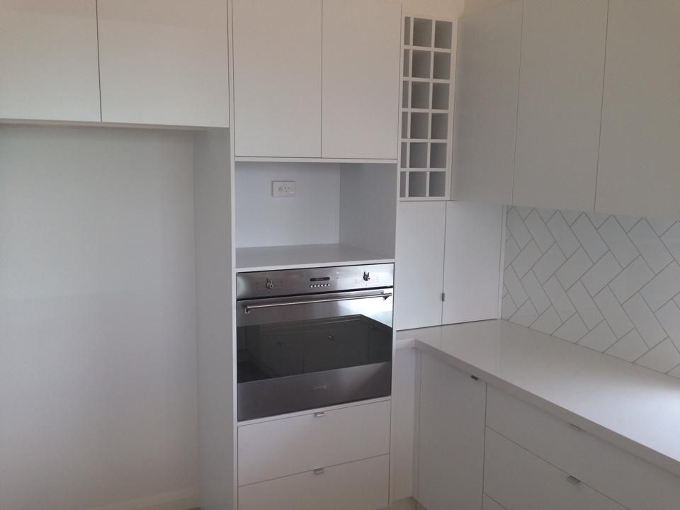 A Kitchen With White Cabinets and a Stainless Steel Oven — Moore Than Just Kitchens In Manilla, NSW