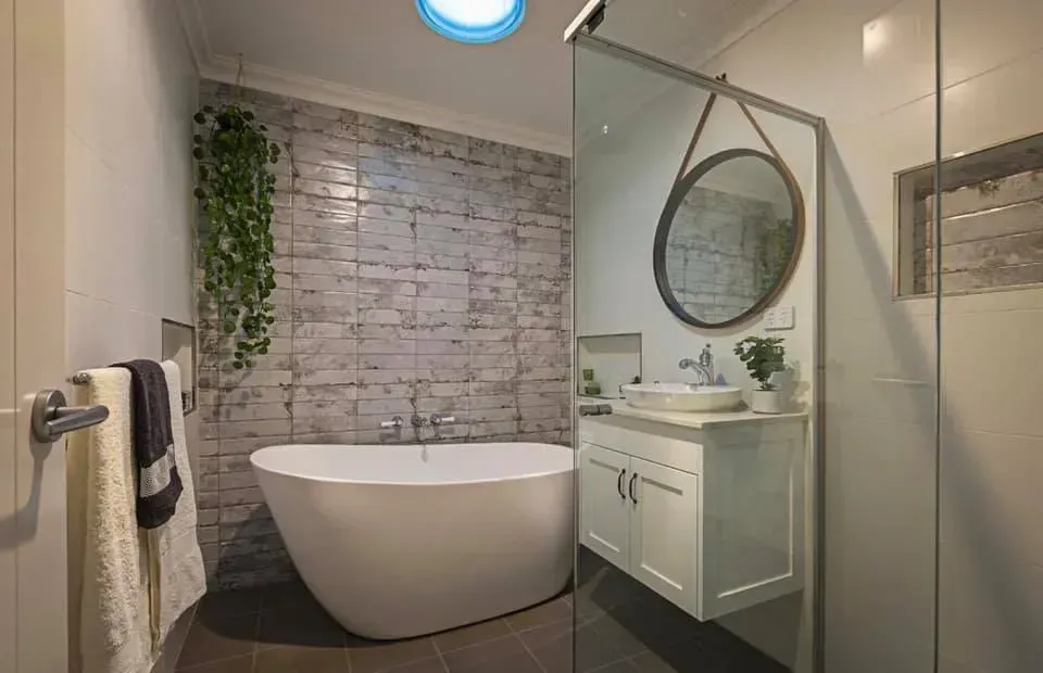 A Bathroom With a Bathtub, Sink, Mirror and Skylight — Moore Than Just Kitchens In Manilla, NSW