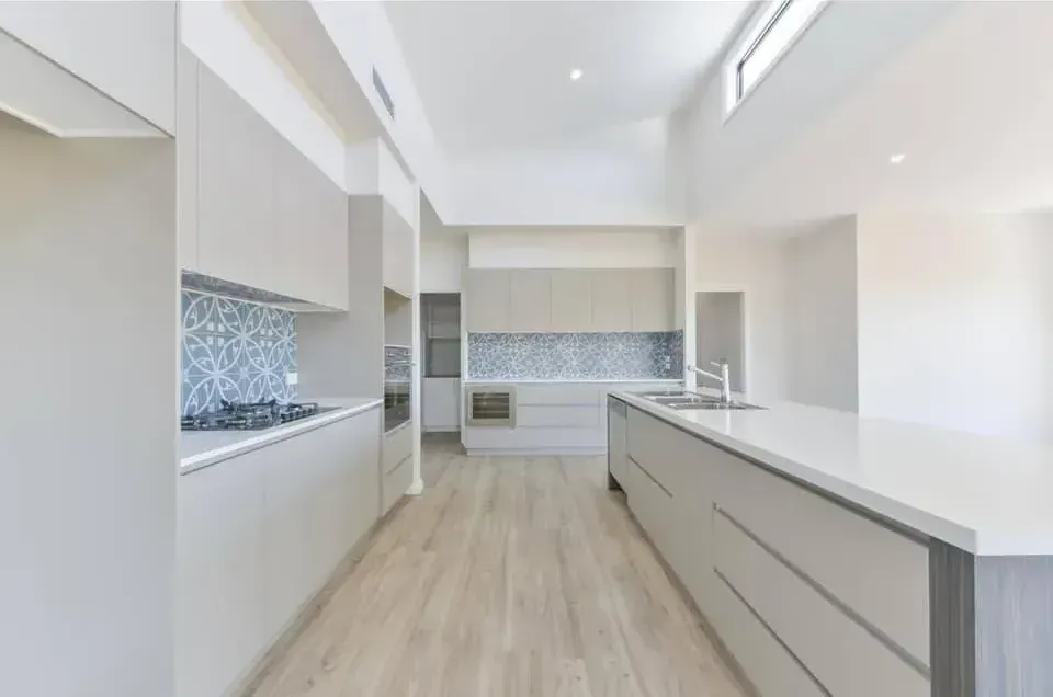 A Kitchen With White Cabinets and a Large Island — Moore Than Just Kitchens In Manilla, NSW