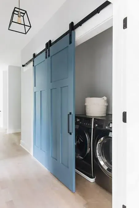 A Laundry Room With a Blue Sliding Barn Door and a Washer and Dryer — Moore Than Just Kitchens In Manilla, NSW