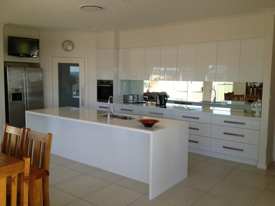 A Kitchen With White Cabinets and a Large Island — Moore Than Just Kitchens In Manilla, NSW
