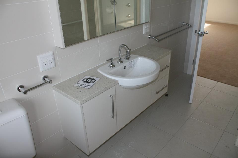 A Bathroom With a Sink, Toilet and Mirror — Moore Than Just Kitchens In Narrabri, NSW