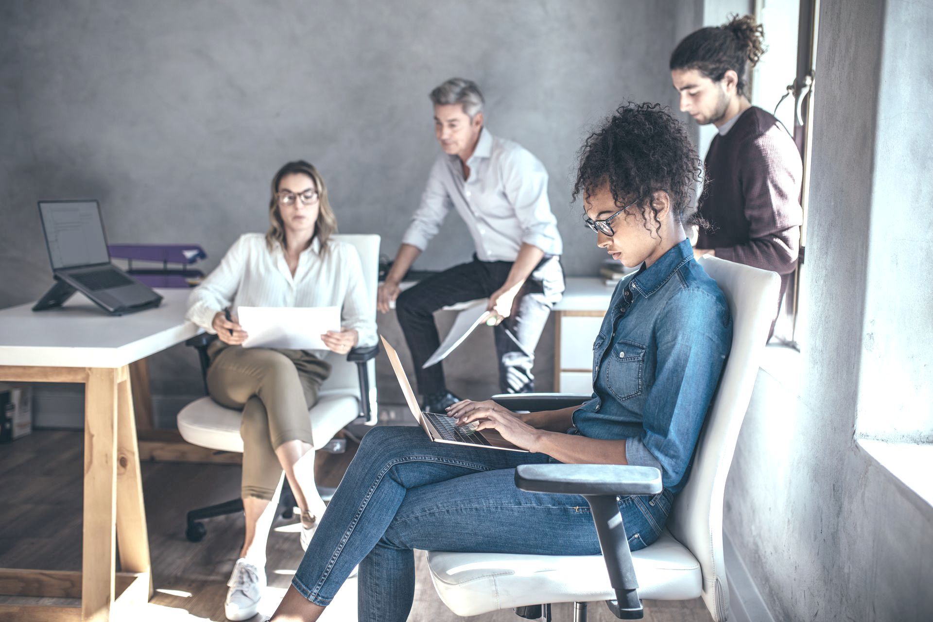 a group of people with laptops in an office