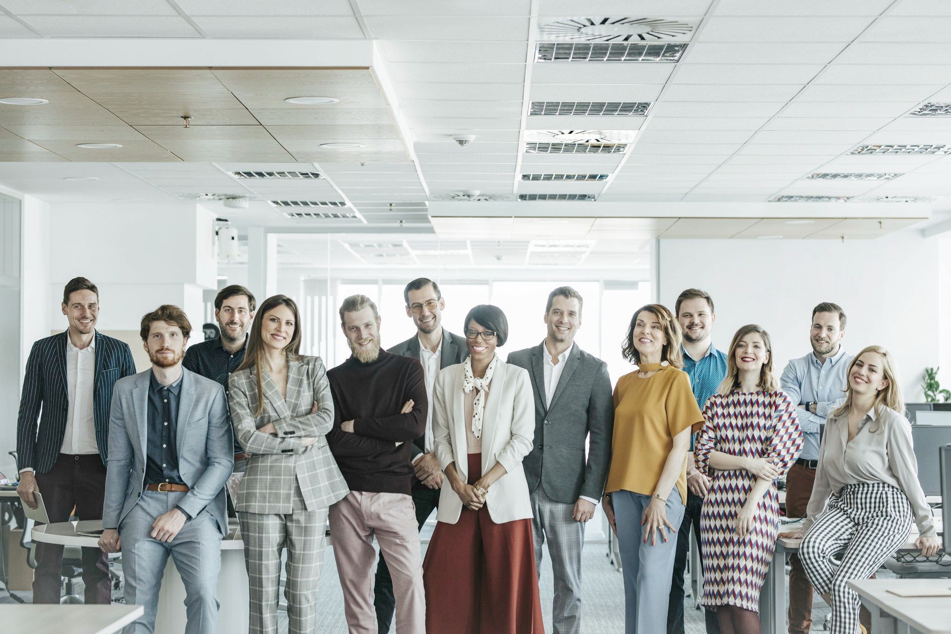 A group of people are posing for a picture in an office.