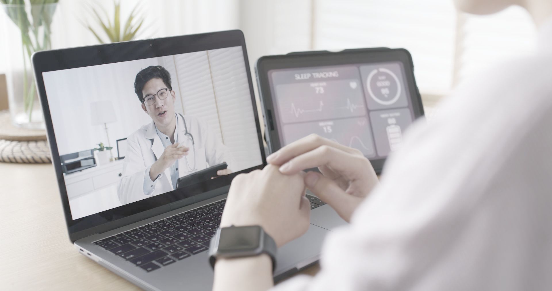 A person is having a video call with a doctor on a laptop.