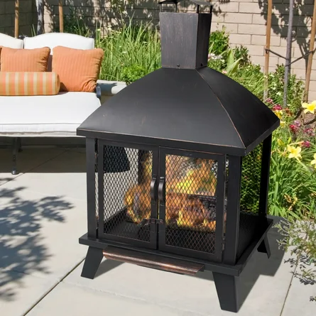 A fire pit is sitting on a patio next to a couch