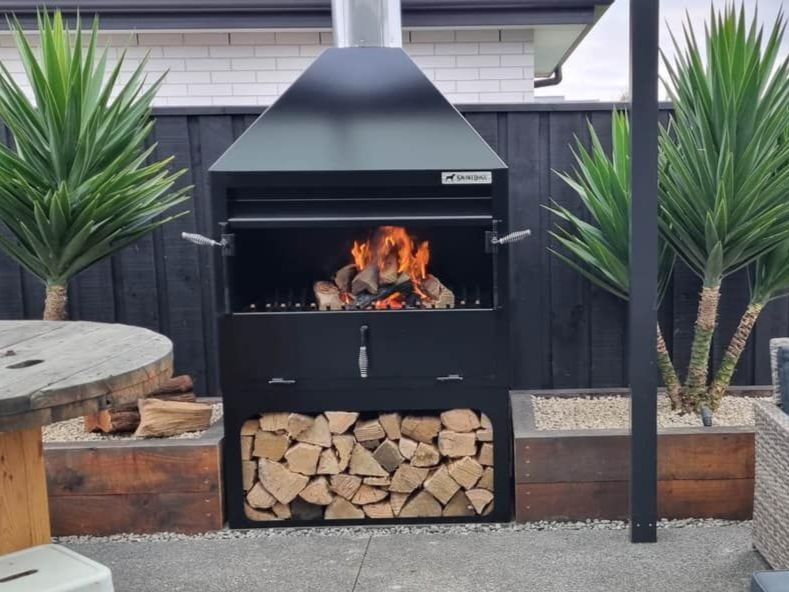A black fireplace with flames coming out of it
