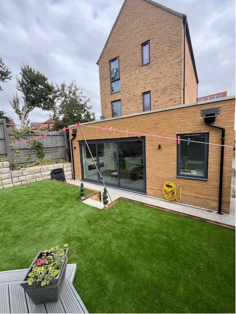 Completed rear house extension with artificial lawn and landscaping in South London
