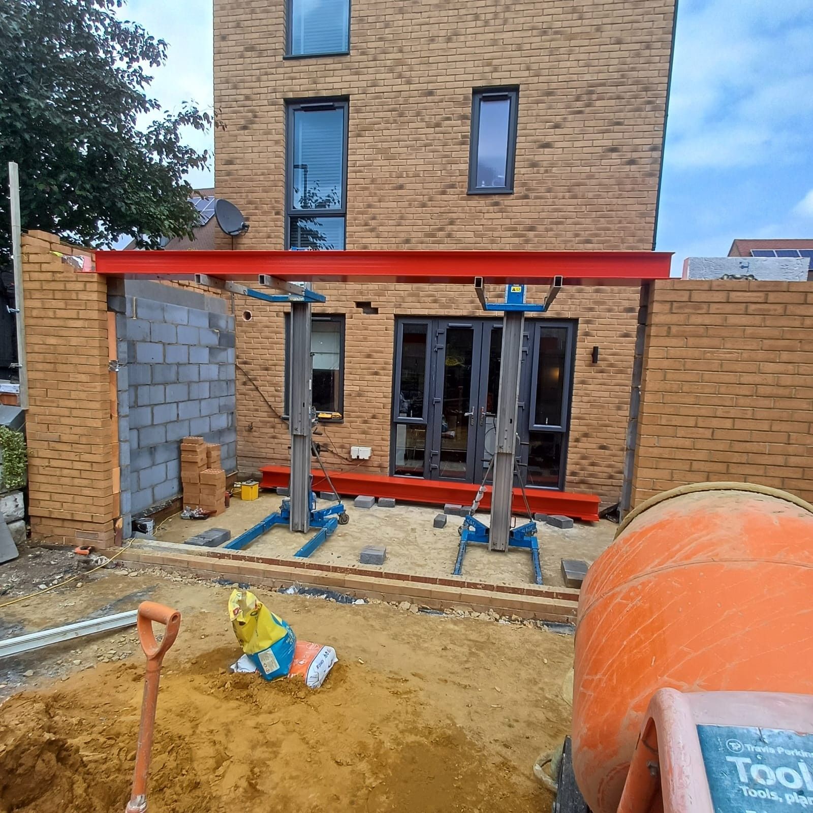 Rear house extension under construction showing blockwork and steel beam, South London
