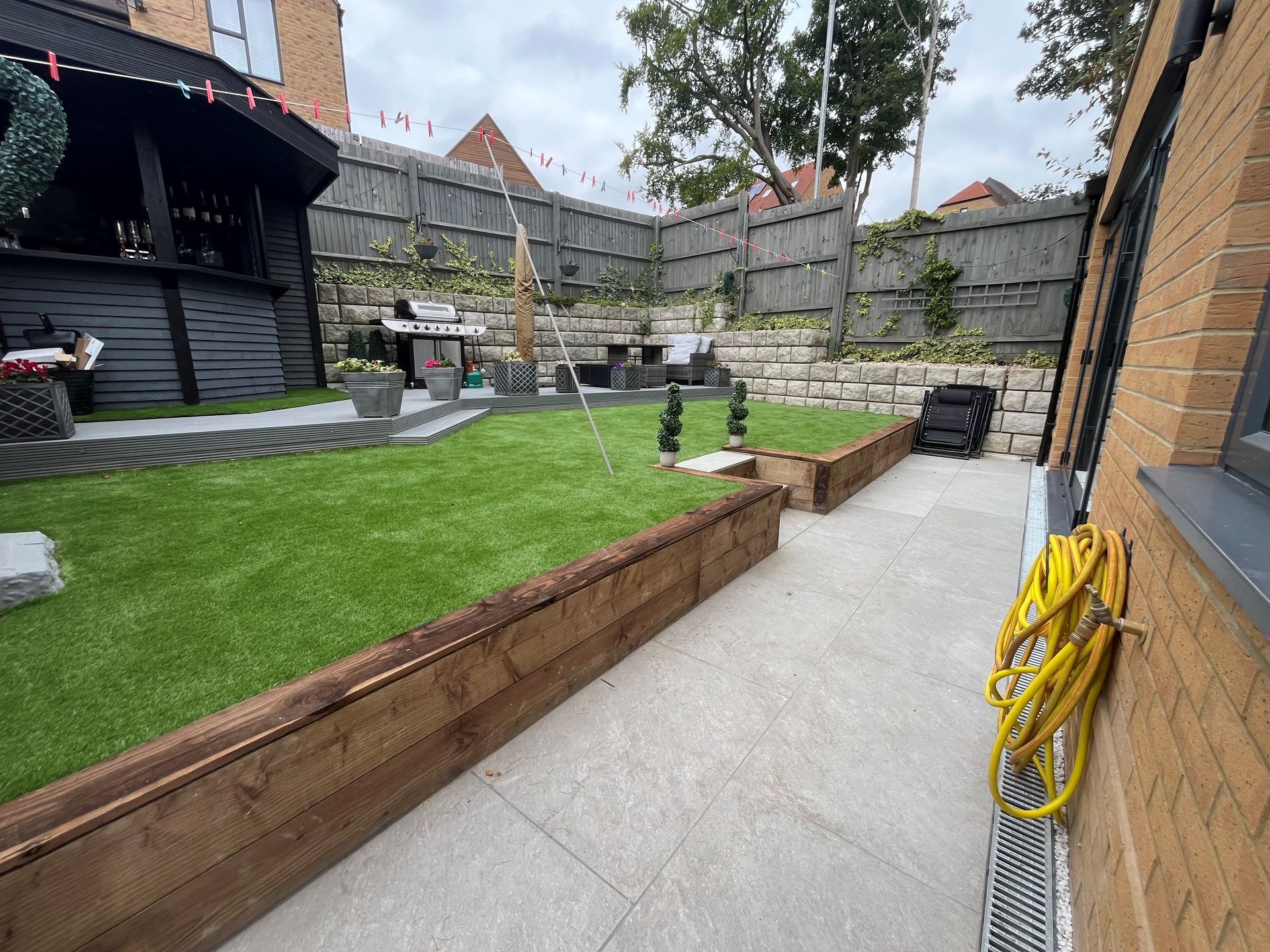 Completed rear house extension with artificial lawn and landscaping in South London