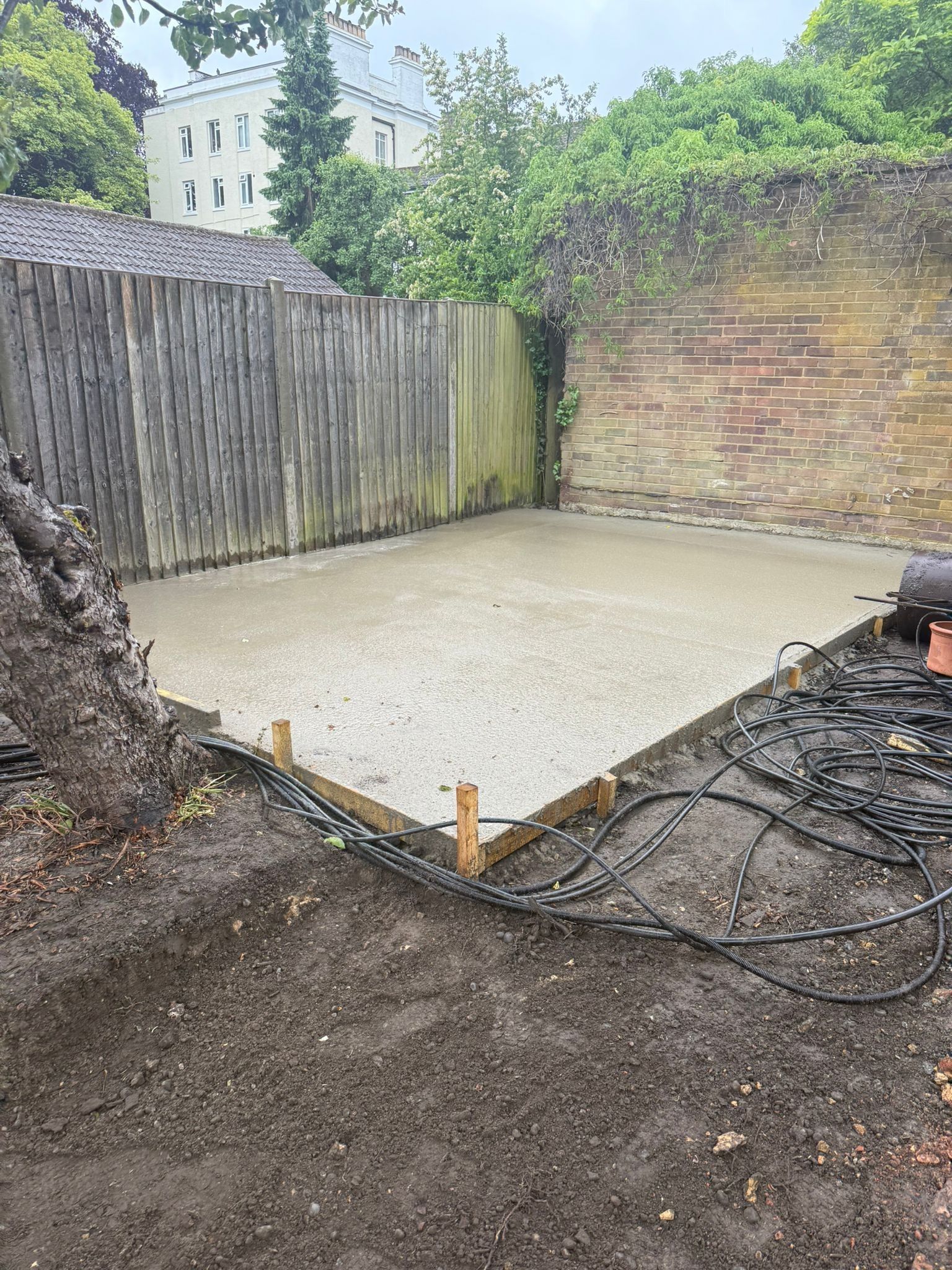 Existing garden boundary before concrete slab and shed construction works