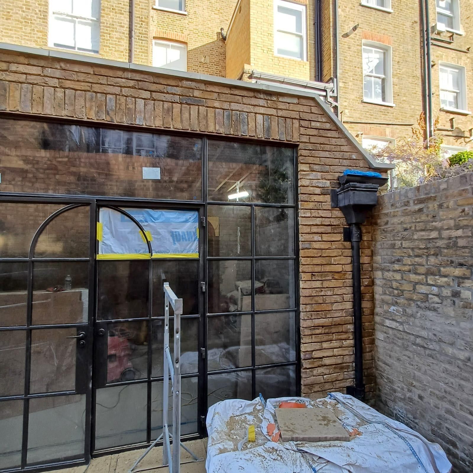 Scaffolded brick facade before repointing, Leytonstone
