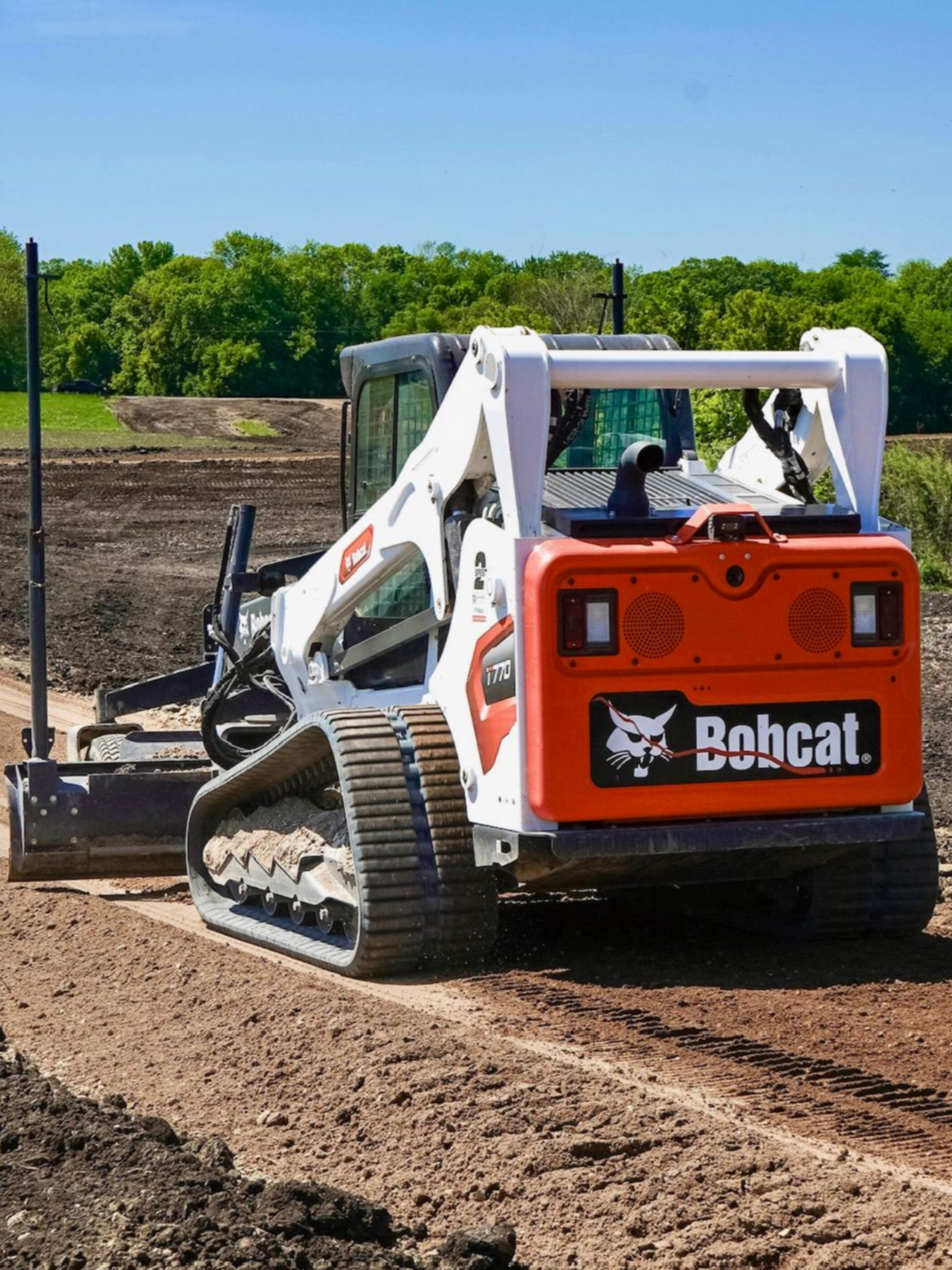 Bobcat T770 skid steer grading residential driveway in Cokato, MN