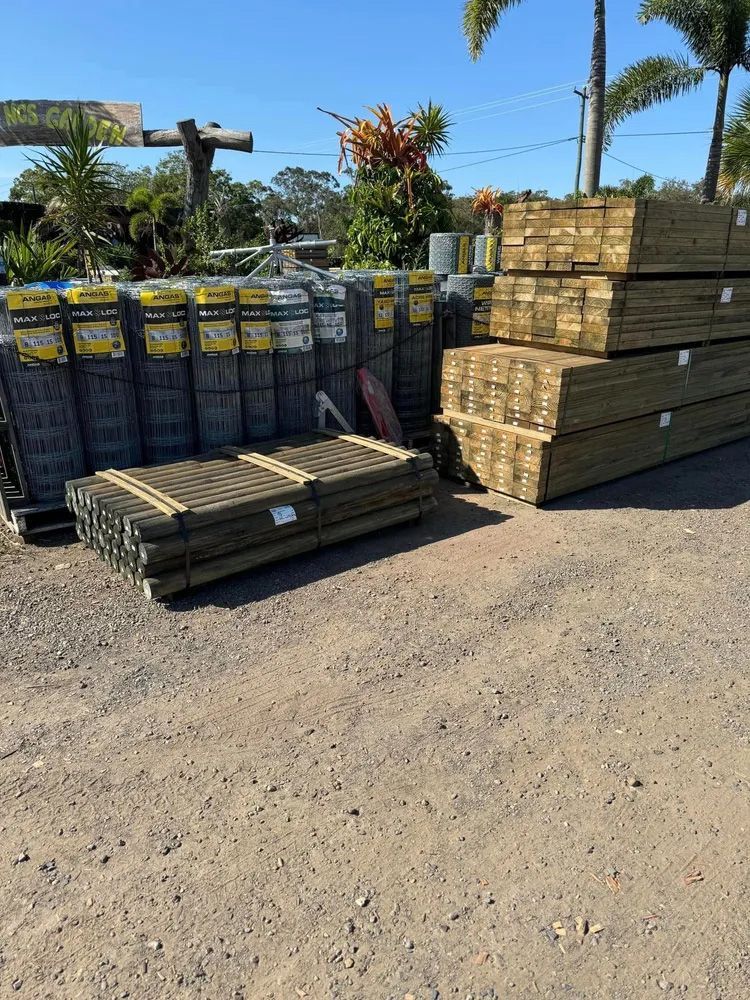 A Bunch of Wooden Pallets Are Stacked on Top of Each Other — Howard Landscape and Produce Supplies in Hervey Bay, QLD