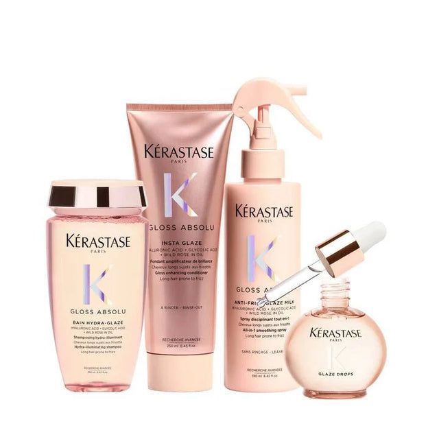 Four Kerastase hair products, in pink bottles and tubes, set against a white background.