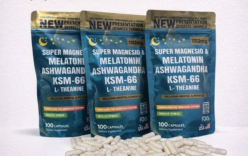 Tres bolsas de suplementos de color verde azulado etiquetadas como KSM-66 ashwagandha con cápsulas esparcidas al frente.