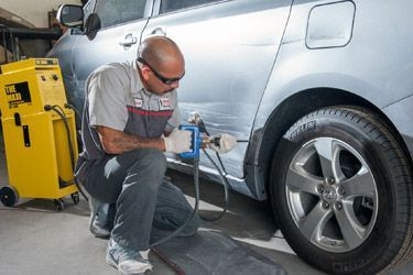 Autobody repair specialist at work repairing a dent.