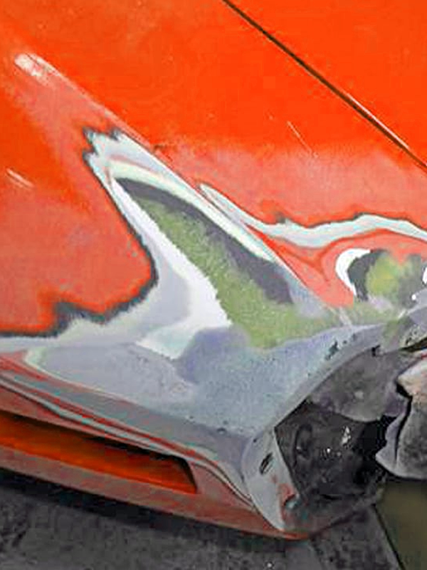 Fiberglass car body panel repair in progress on an orange car. Fiberglass car body panel repair in progress on an orange car.