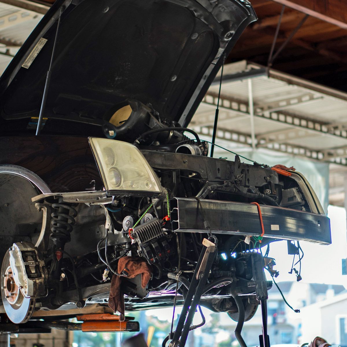 Front-end collision repair on a black car. Front-end collision repair on a black car.