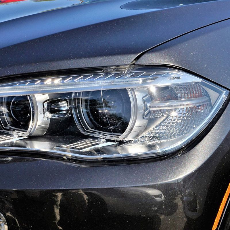 Completely repaired front bumper on a grey car.