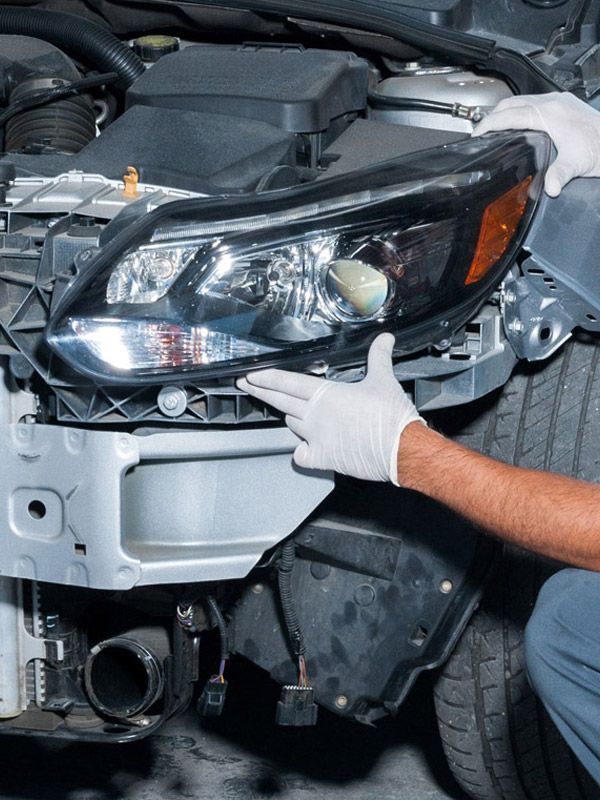 Repairing front-end collision damage on a car.