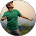 A man in a green shirt is standing in a circle with his arms outstretched.