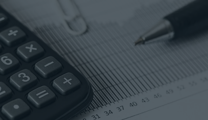 Calculator on a spreadsheet with a pen in the background