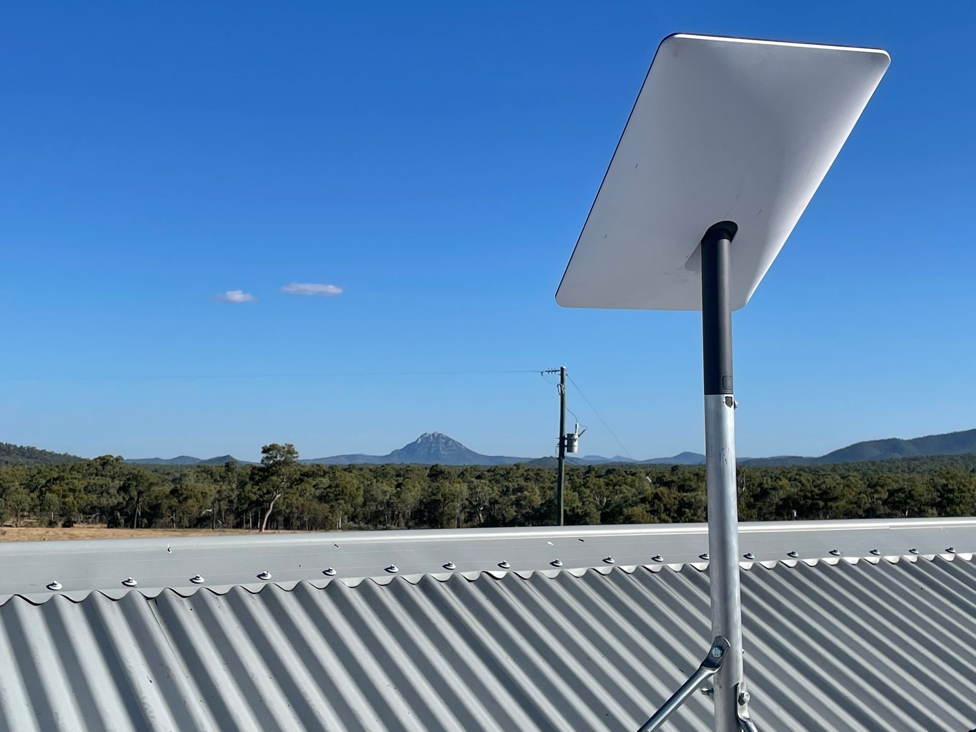 White Starlink Satellite Dish on a Pole — Apex Antenna Solutions Pty Ltd in Cannonvale, QLD