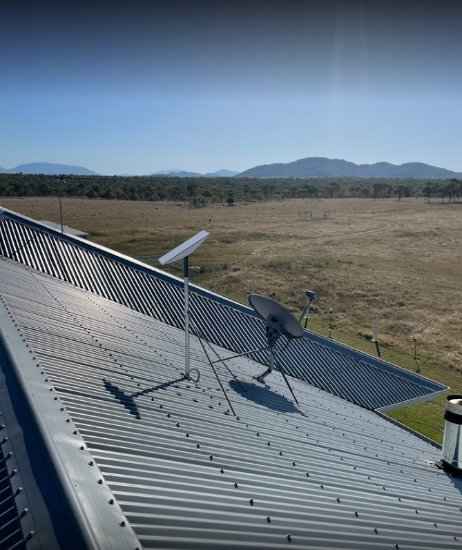Two Satellite Dishes on a Corrugated Metal Roof — Apex Antenna Solutions Pty Ltd in Bowen, QLD