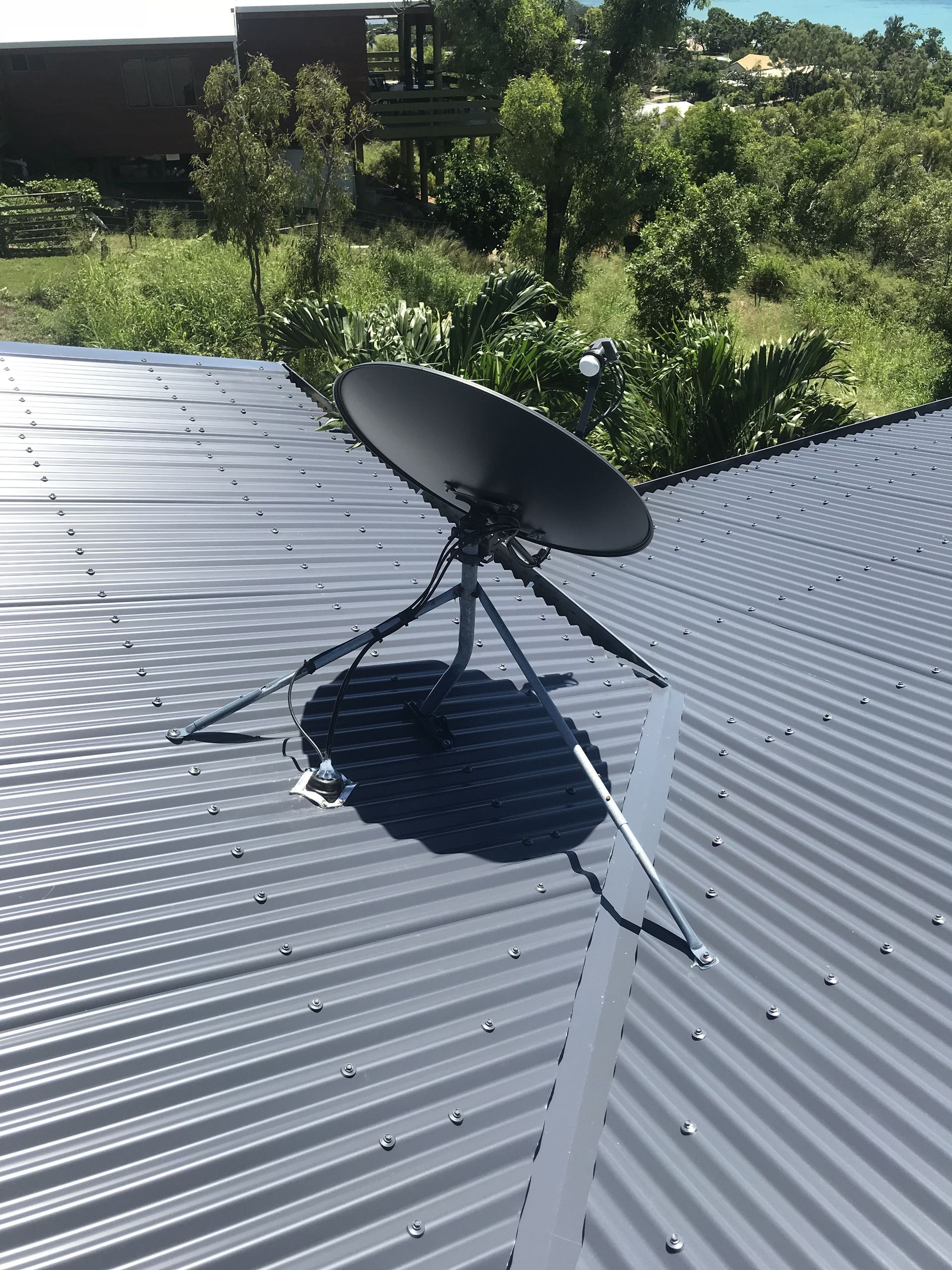 Satellite Dish on Red-roofed House — Apex Antenna Solutions Pty Ltd in Proserpine, QLD
