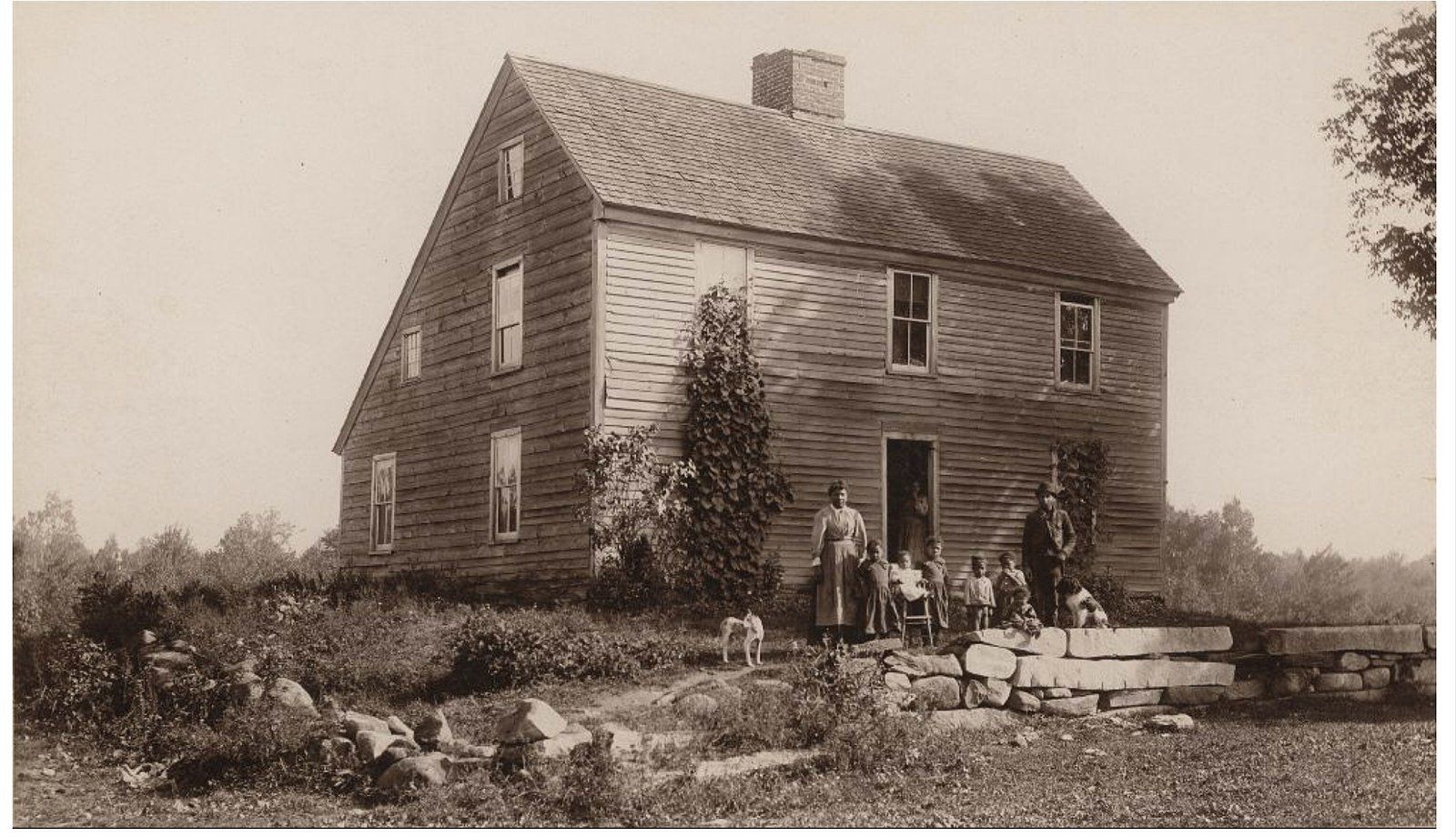 A black and white photo of a large wooden house