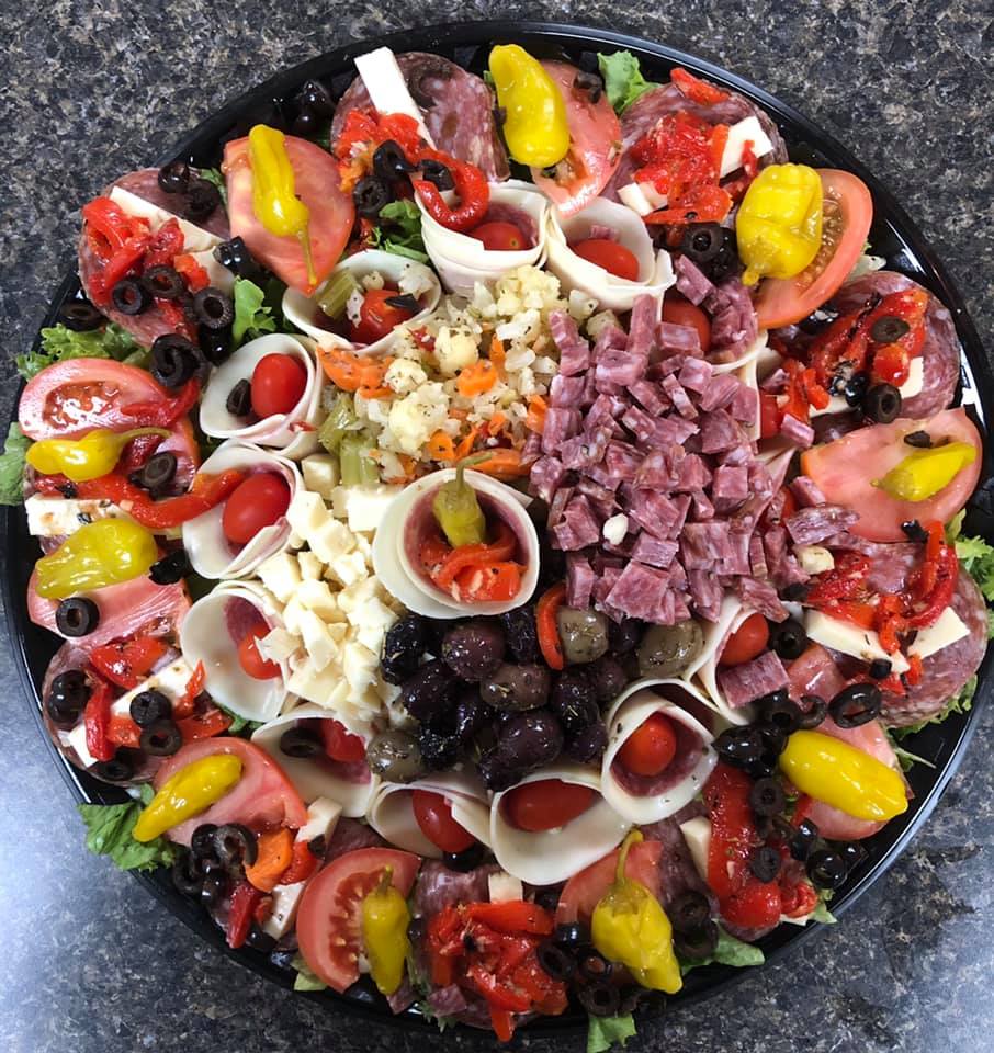 A black plate filled with lots of different types of food