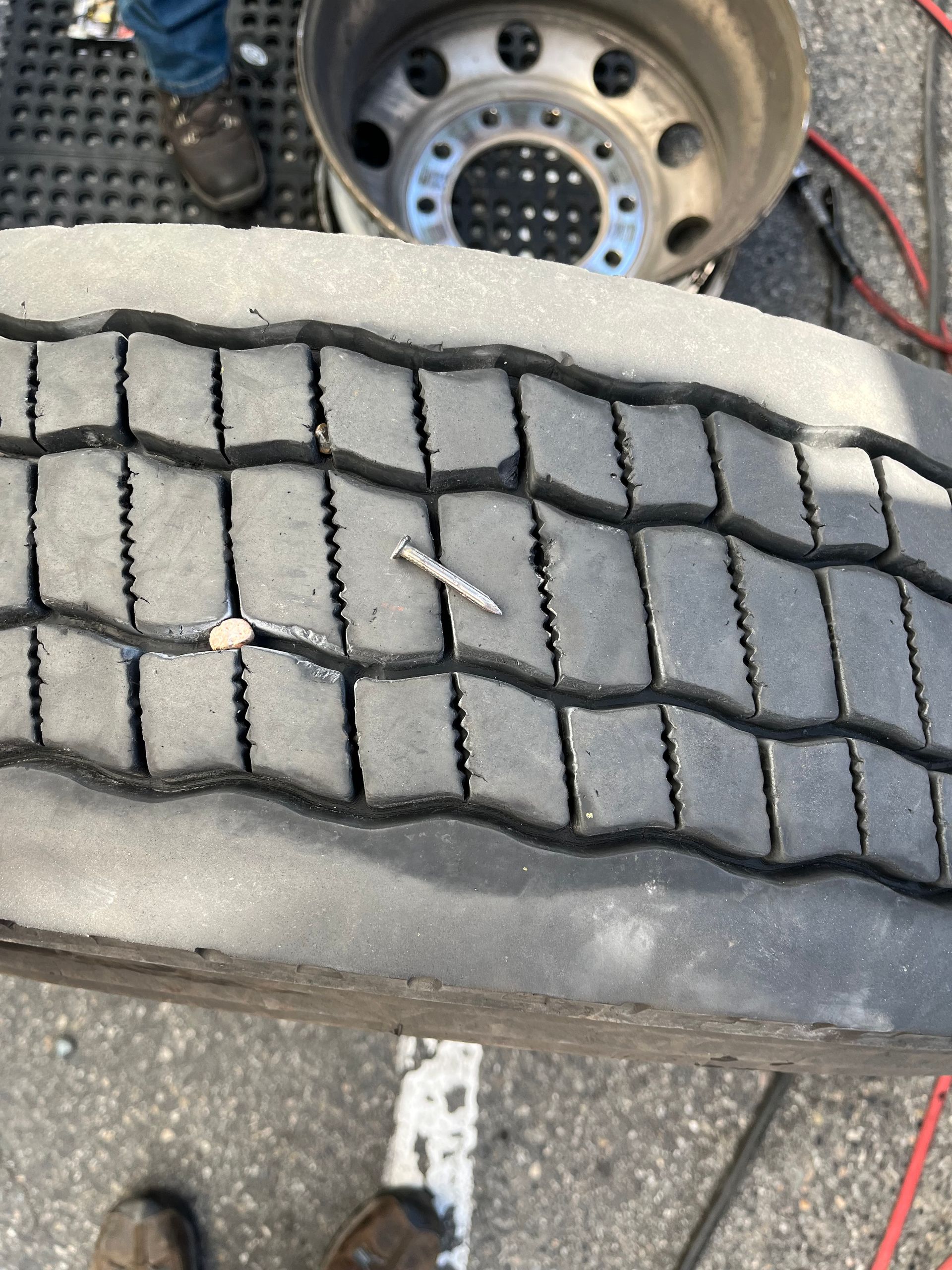 A tire with a nail sticking out of it