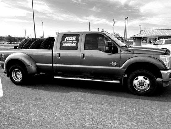 A black and white photo of a pickup truck parked in a parking lot.