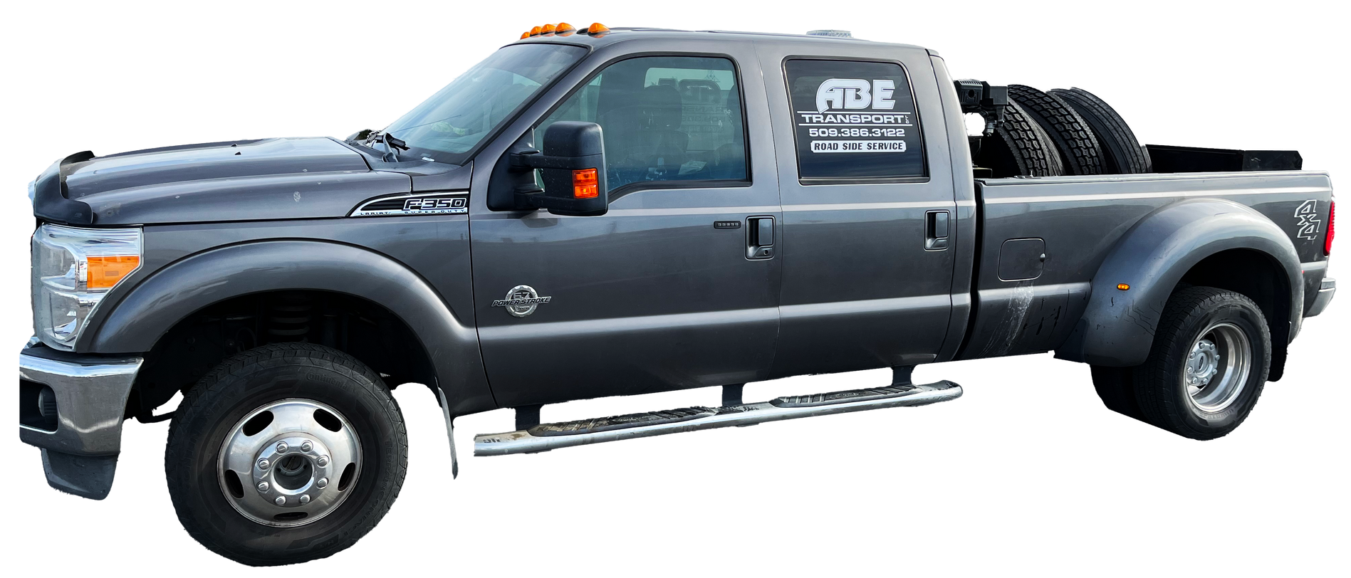 A gray pickup truck with tires in the bed on a white background.