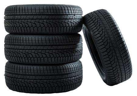 Four tires are stacked on top of each other on a white background.
